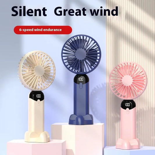 Three portable fans in beige, blue, and pink on a light background with text 'Silent Great wind' and '6-speed wind endurance'.