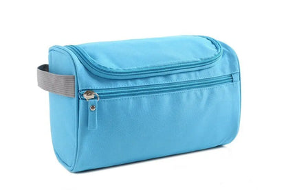 Blue toiletry bag with a gray strap on a white background